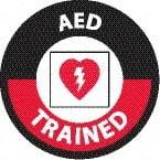 NMC - AED Trained, Hard Hat Label - Round, White & Red on Black, 0.004" Thick, Indoor or Outdoor, Adhesive Backed, For Accident Prevention - Apex Tool & Supply